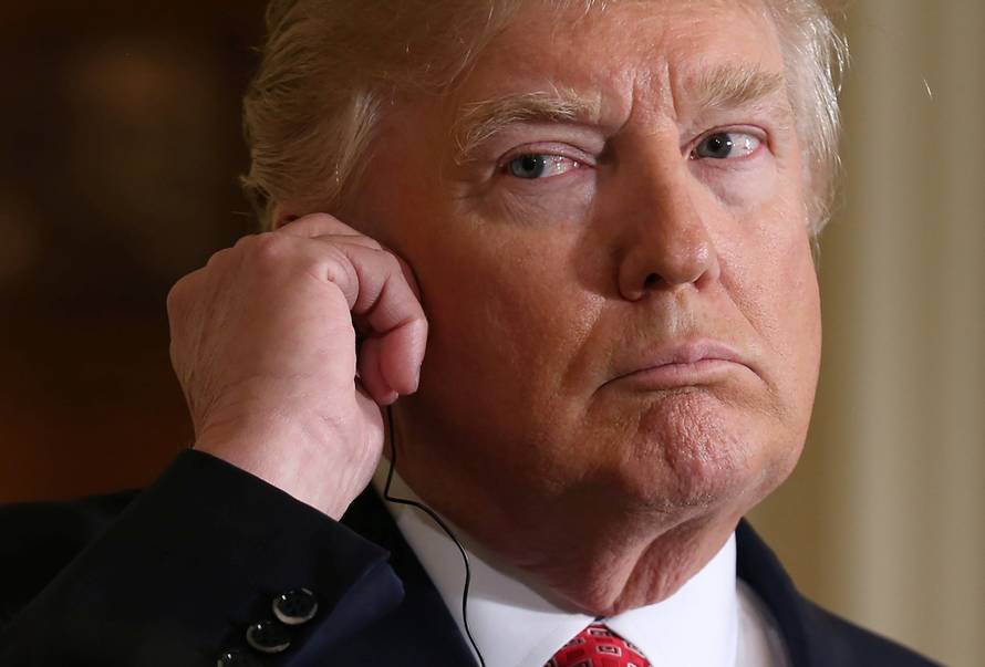 U.S. President Donald Trump listens to a translation during a joint news conference with Japanese Prime Minister Shinzo Abe at the White House in Washington