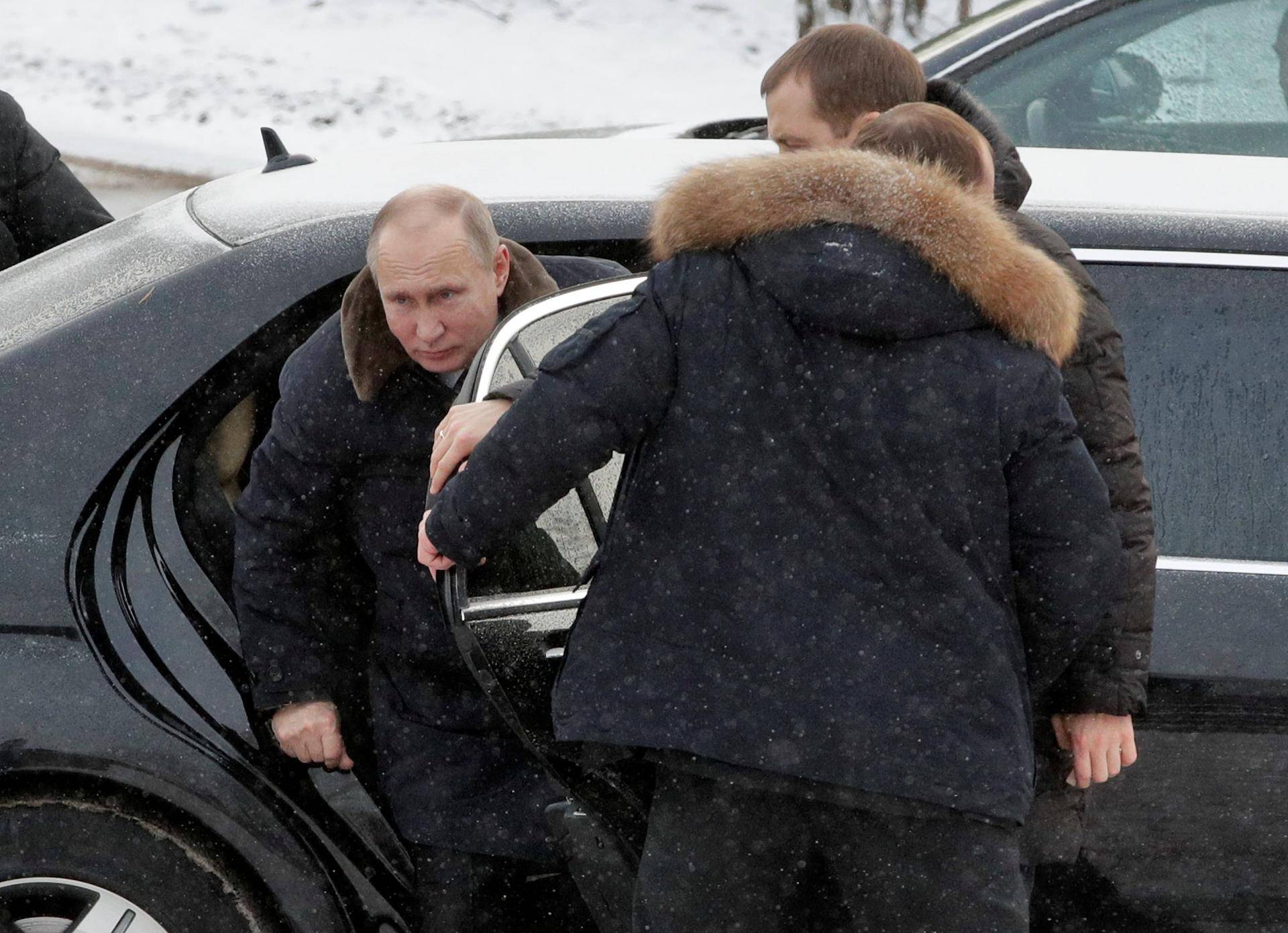 Russian President Vladimir Putin leaves a car as he arrives to visit a monument at Nevsky Pyatachok, an area southeast of St. Petersburg, in Leningrad region