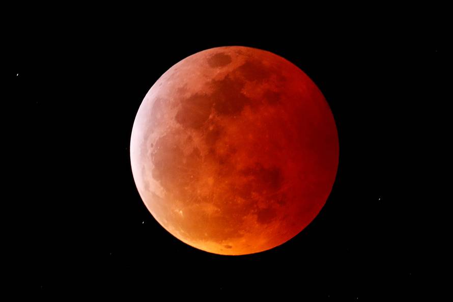 A total lunar eclipse that is called a 'Super Blood Wolf Moon' is seen from Encinitas, California