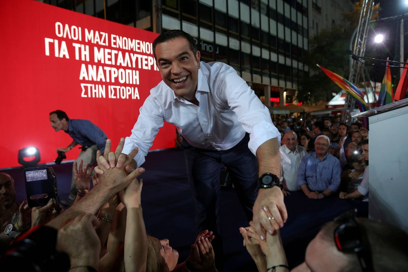 Greek PM and leader of leftist Syriza party Tsipras greets supporters before his speech during a pre-election rally in Athens