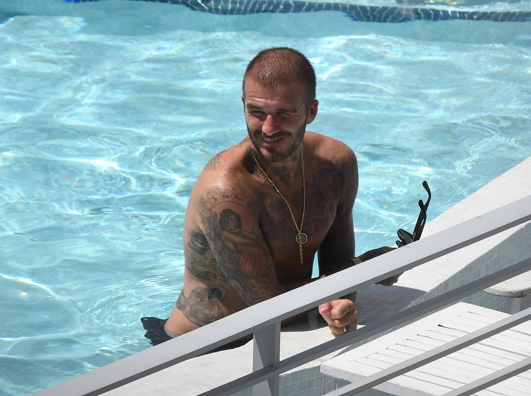 Shirtless David Beckham celebrates his new team, Inter Miami, as he has a few cocktails and takes a dip in the pool in Miami