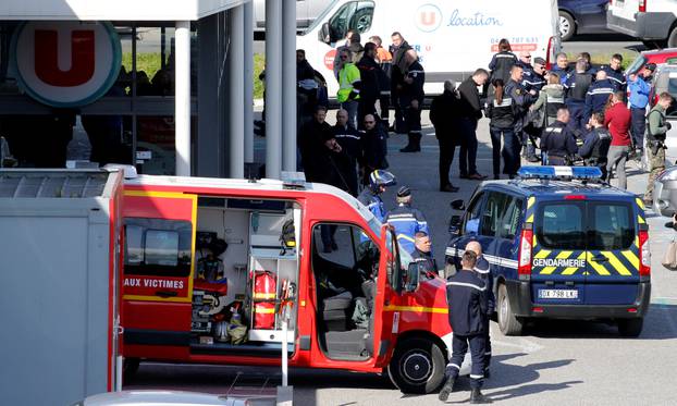 A general view shows gendarmes and police officers at a supermarket after a hostage situation in Trebes