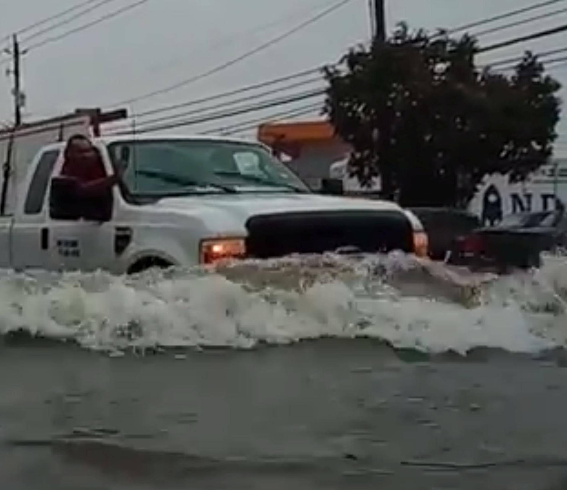 A car passes through a flooded street as storm Imelda hits Houston