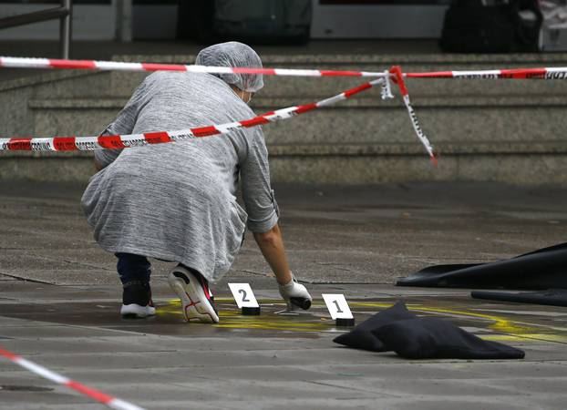 Police investigator works at the crime scene after a knife attack in a supermarket in Hamburg