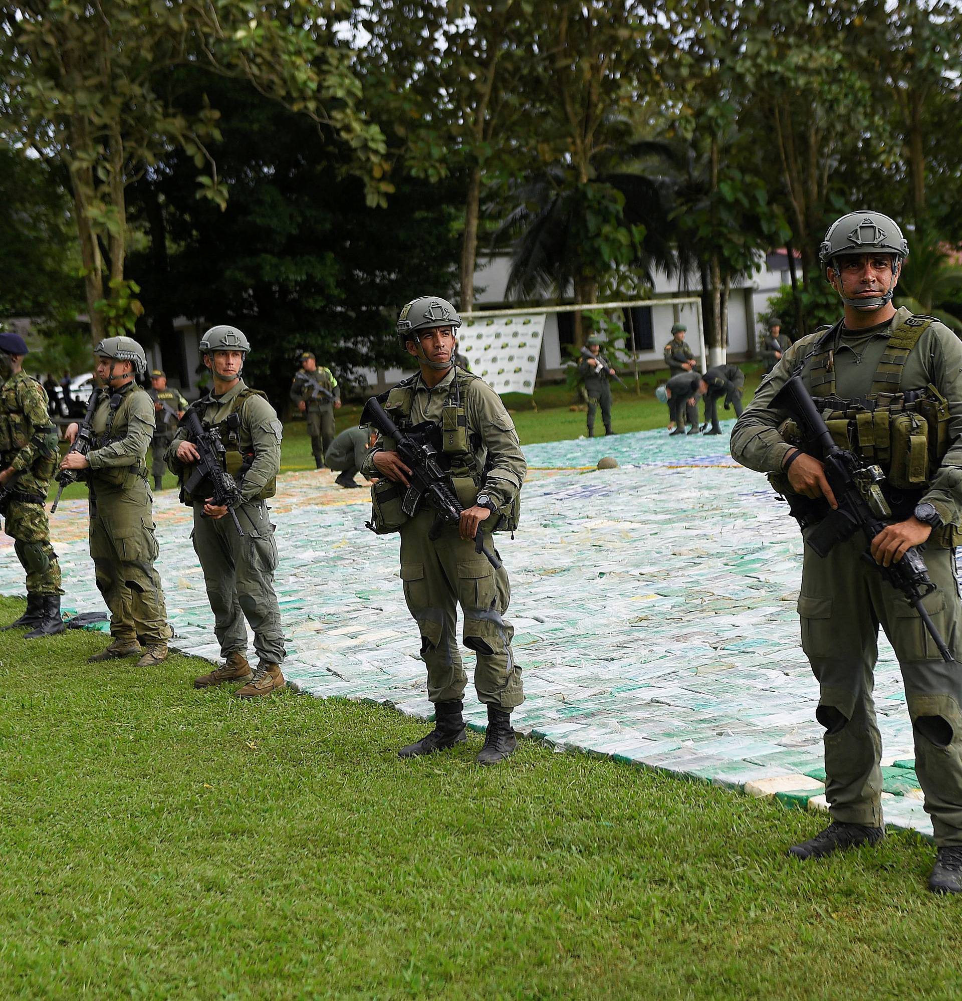 Colombian police and soldiers guard more than 12 tons of seized cocaine in Apartado, Colombia