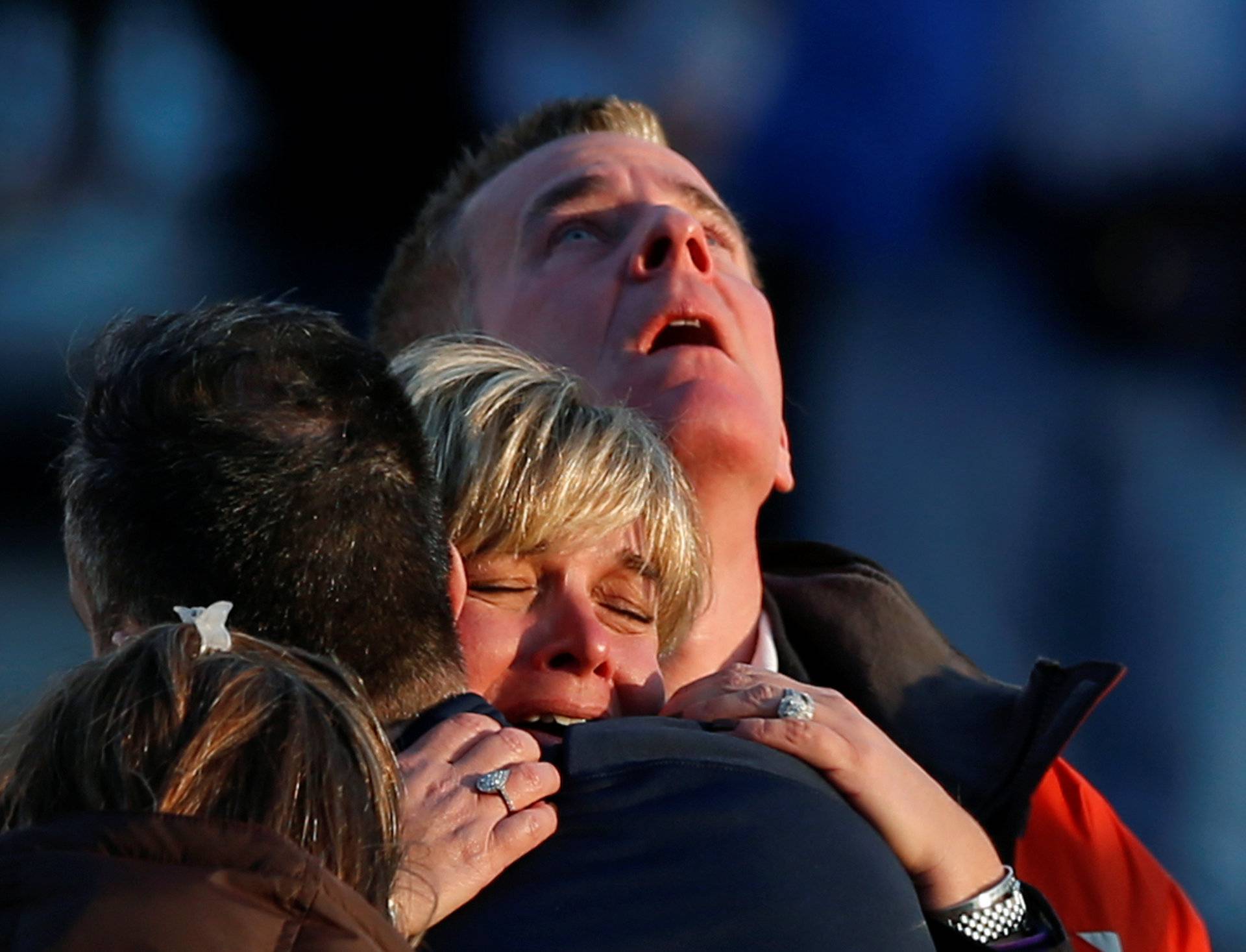 FILE PHOTO: Lynn and Christopher McDonnell, the parents of seven-year-old Grace McDonnell, grieve near Sandy Hook Elementary in Newtown,