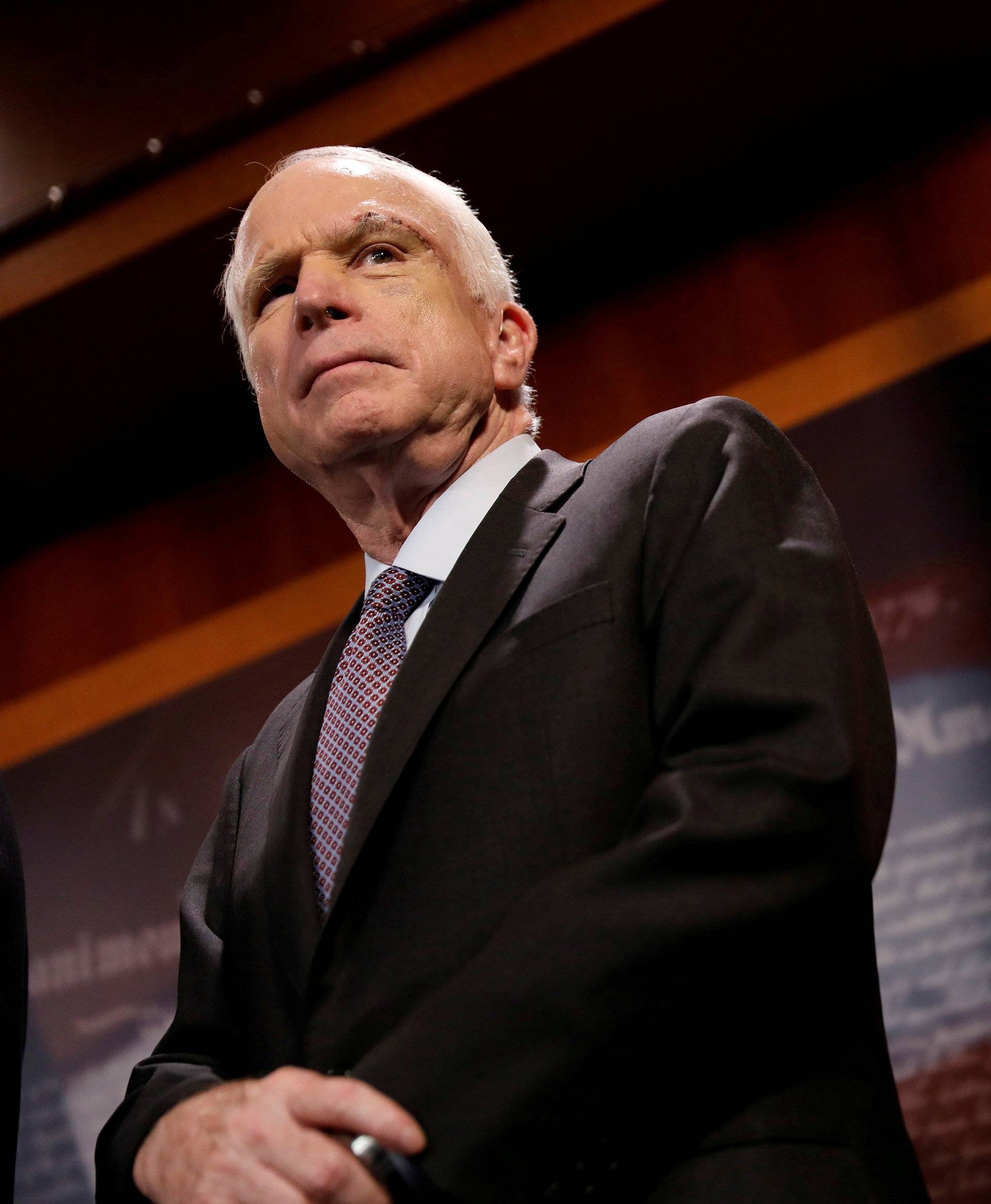 FILE PHOTO:    Senator John McCain (R-AZ) looks on during a press conference about his resistance to the so-called "Skinny Repeal" of the Affordable Care Act on Capitol Hill in Washington