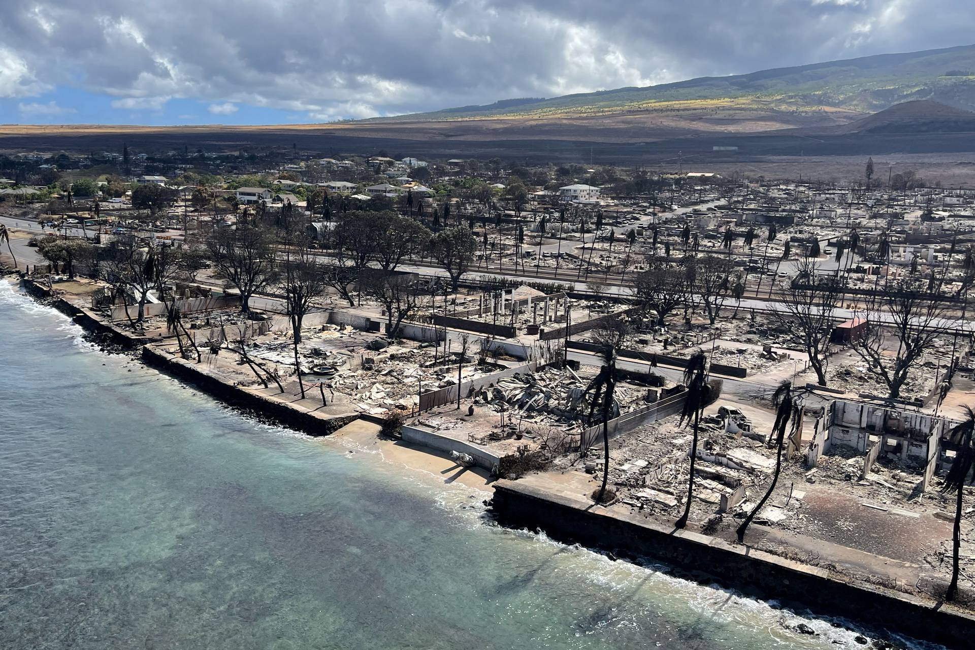 The shells of burned houses and buildings are left after wildfires in Lahaina