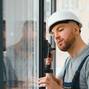 Workman,In,Overalls,Installing,Or,Adjusting,Plastic,Windows,In,The