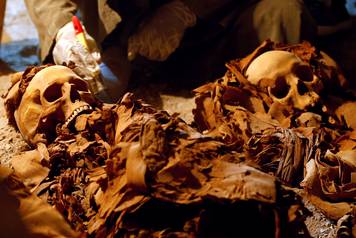 An Egyptian antiquities worker works in the recently discovered tomb of Amenemhat, a goldsmith from the New Kingdom, at the Draa Abu-el Naga necropolis near the Nile city of Luxor