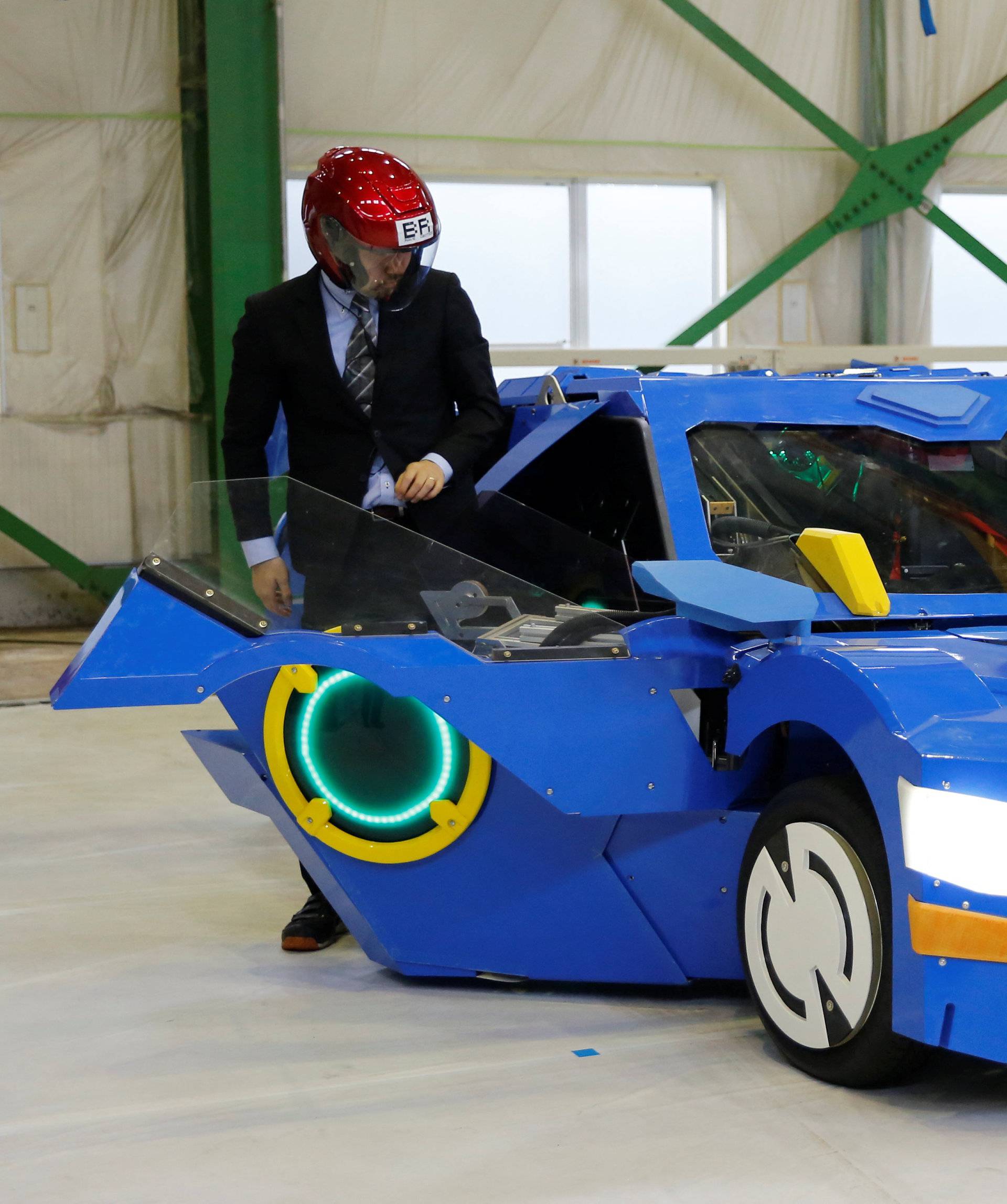 New transforming robot called "J-deite RIDE" that transforms itself into a passenger vehicle, developed by Brave Robotics Inc, Asratec Corp and Sansei Technologies Inc, demonstrates during its unveiling at a factory near Tokyo