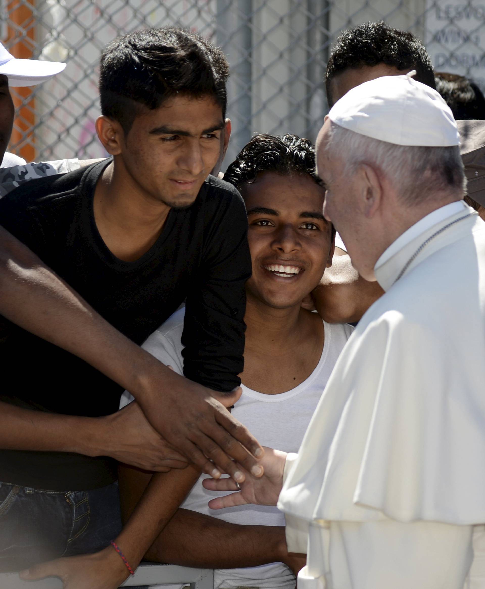 Pope Francis greets migrants and refugees at the Moria refugee camp near the port of Mytilene, on the Greek island of Lesbos 