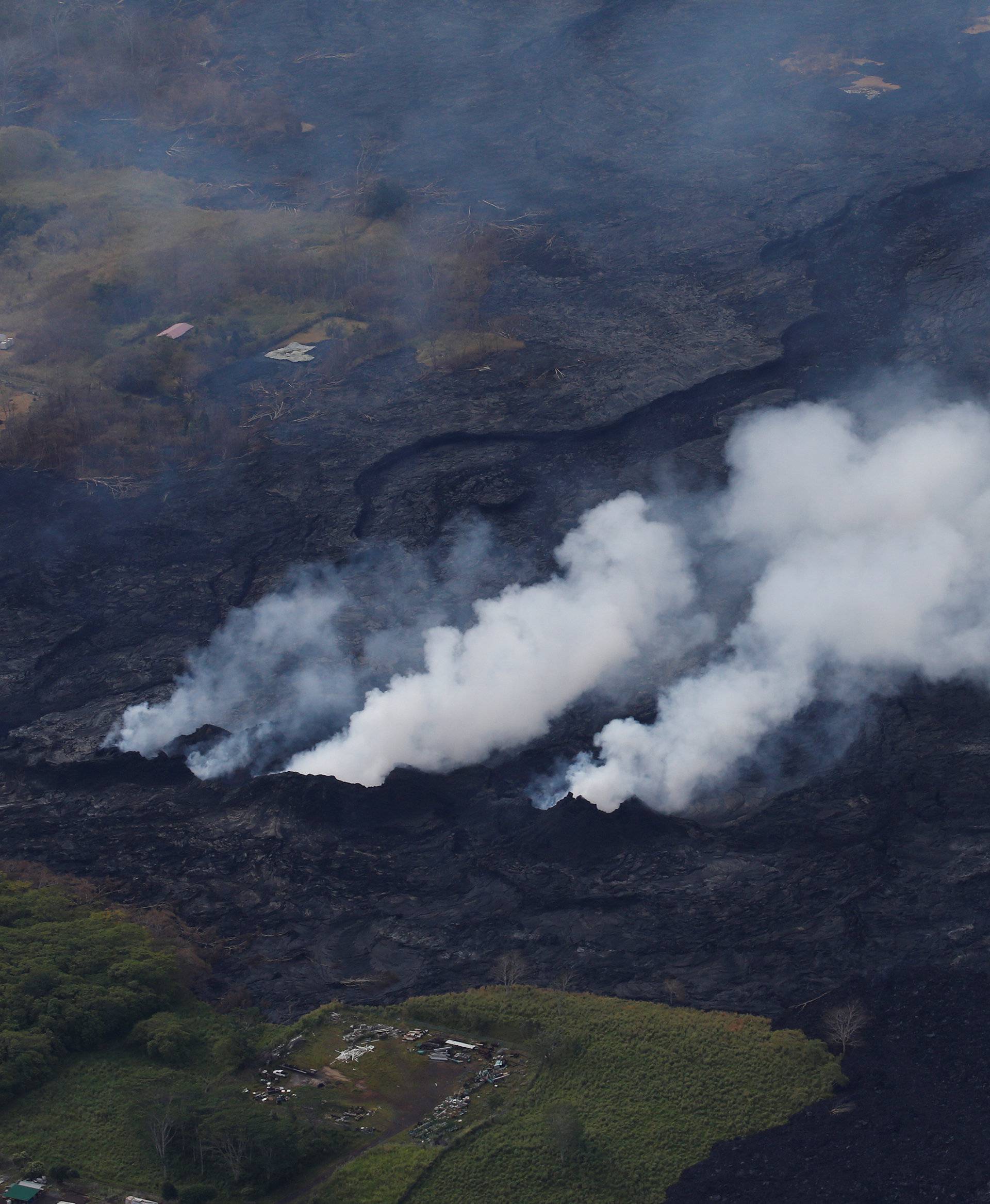 Volcanic gases rise from a fissure on the lava field in the Leilani Estates near Pahoa, Hawaii