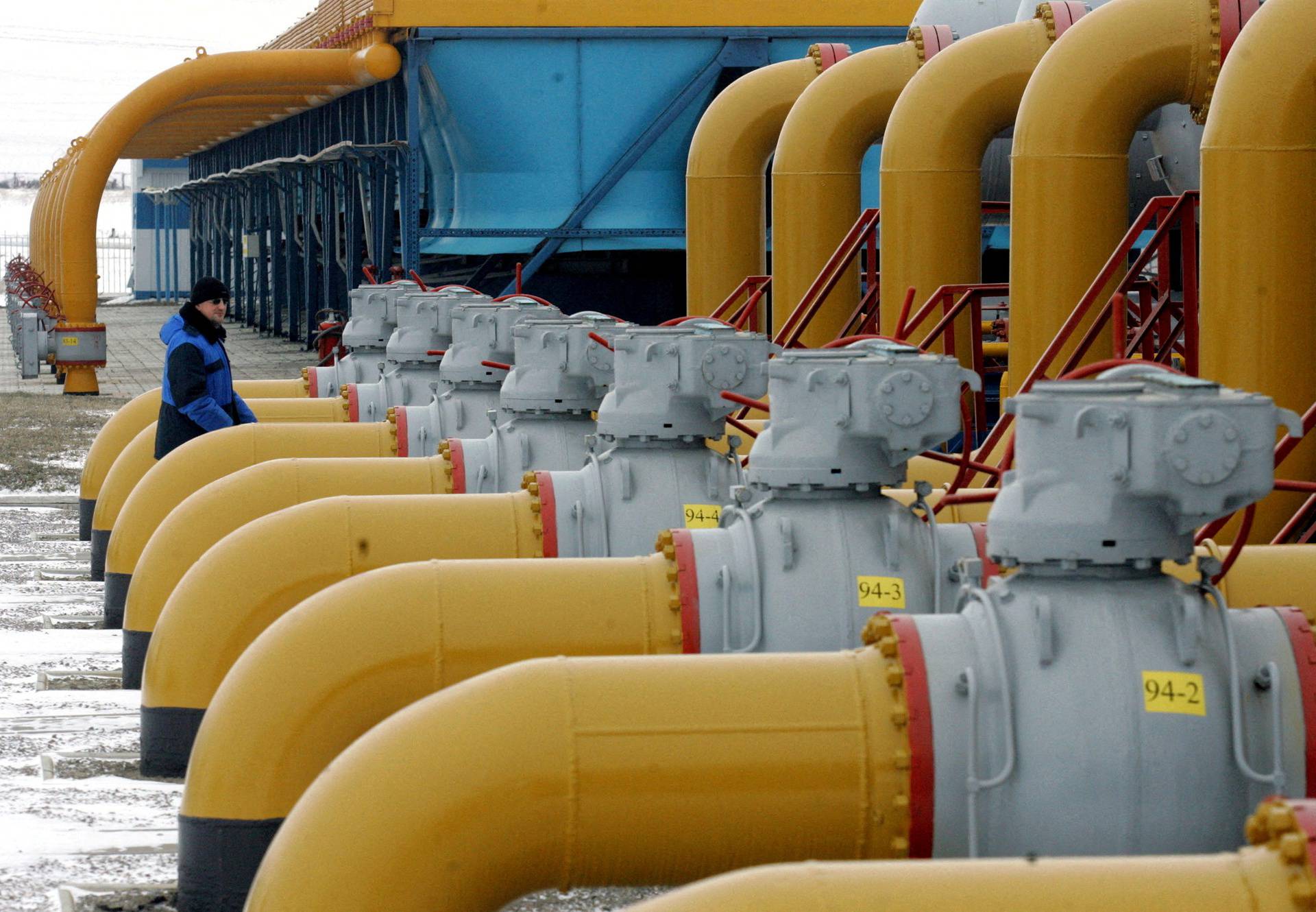 FILE PHOTO: A gas worker walks between pipes in a gas compressor and distribution station near Kursk