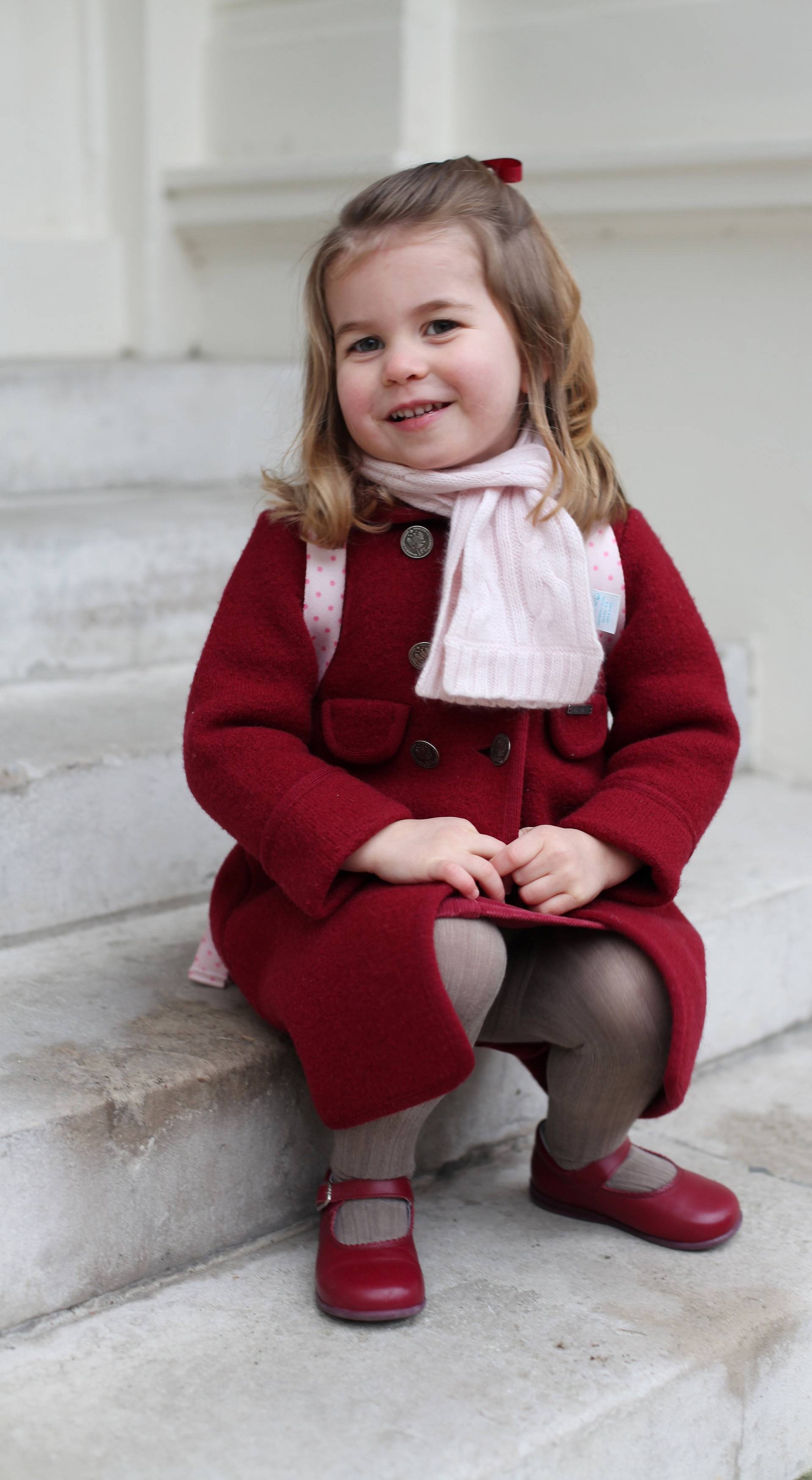 Britain's Princess Charlotte sits on the steps at Kensington Palace in a photograph taken taken by her mother and handed out by Britain's Prince William and Catherine, the Duchess of Cambridge