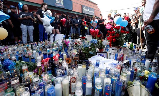 FILE PHOTO: People gather around a makeshift memorial for Grammy-nominated rapper Nipsey Hussle who was shot and killed outside his clothing store in Los Angeles