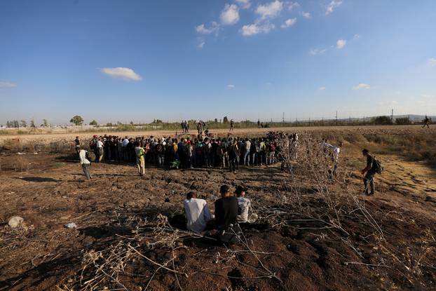 Israeli soldiers check documents of Palestinians as they cross back to the West Bank from Israel by the village of Muqeibila