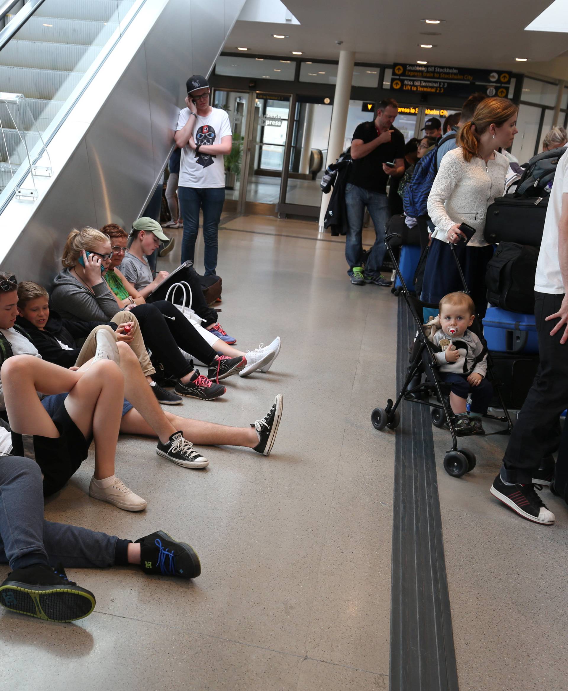 Passengers wait for flight information at the domestic terminal of Arlanda airport in Stockholm