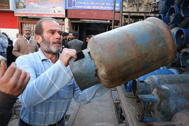 People queue to fill their gas cylinders in Damascus