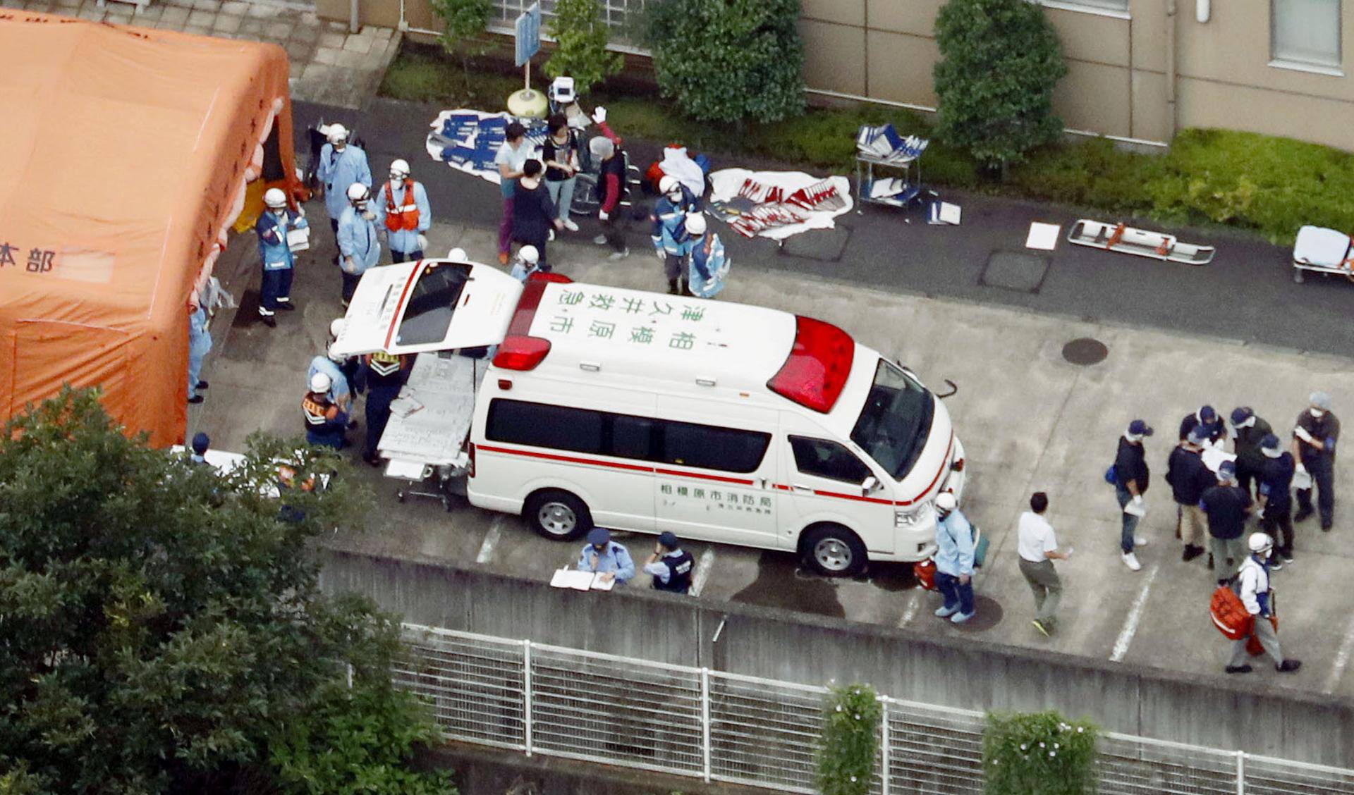 A police officer is seen in a facility for the disabled, where a knife-wielding man attacked, in Sagamihara