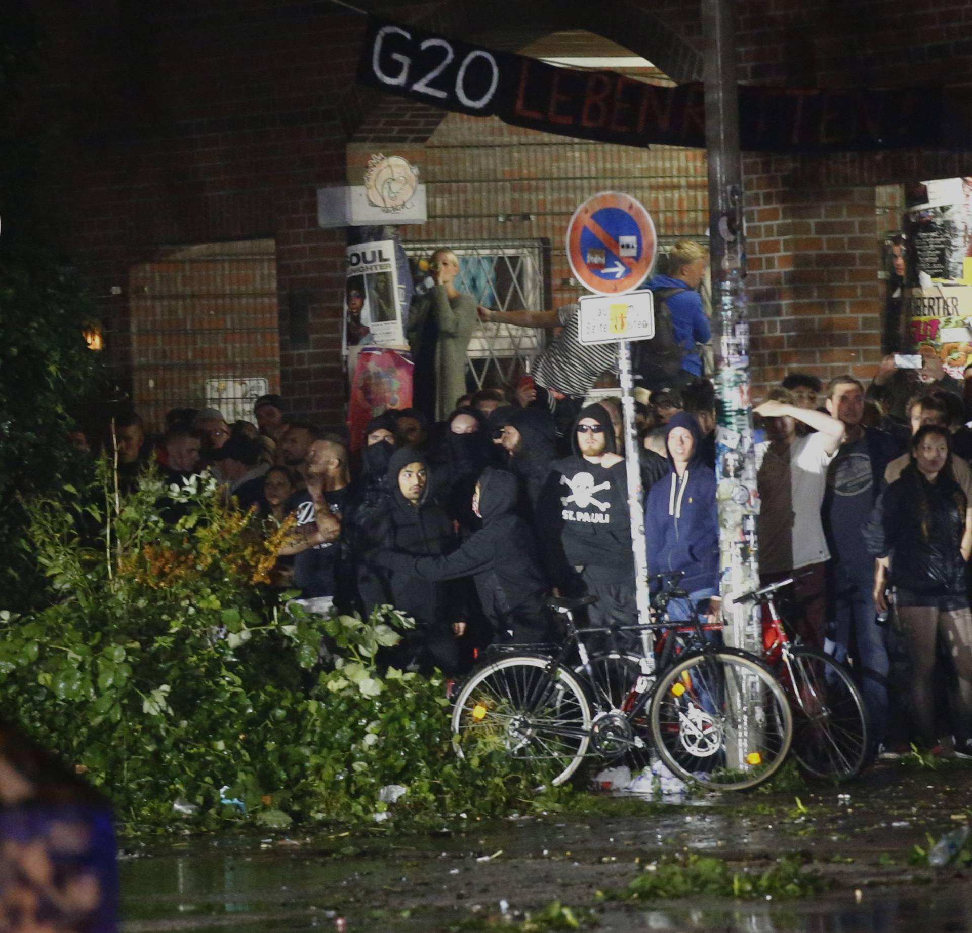 Protestors look for the shelter at the Schanze district following clashes with the police in Hamburg
