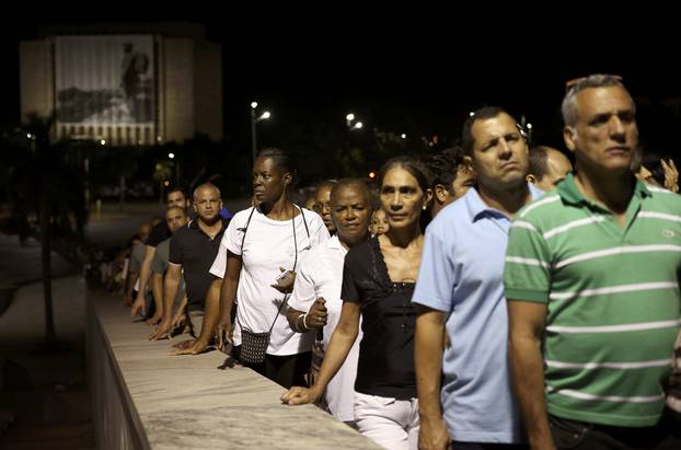 People wait in line to pay tribute to Cuba