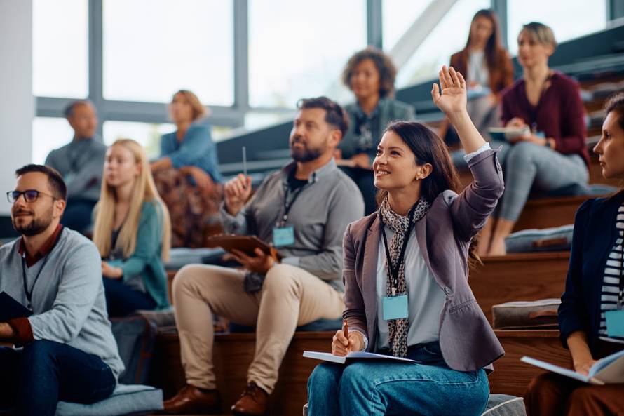 Happy,Businesswoman,Raising,Her,Arm,To,Answer,The,Question,During