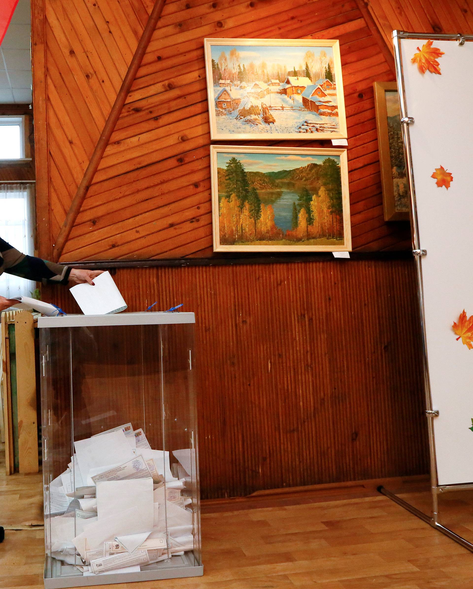 Woman casts her ballot at polling station during parliamentary election in Krasnoyarsk region