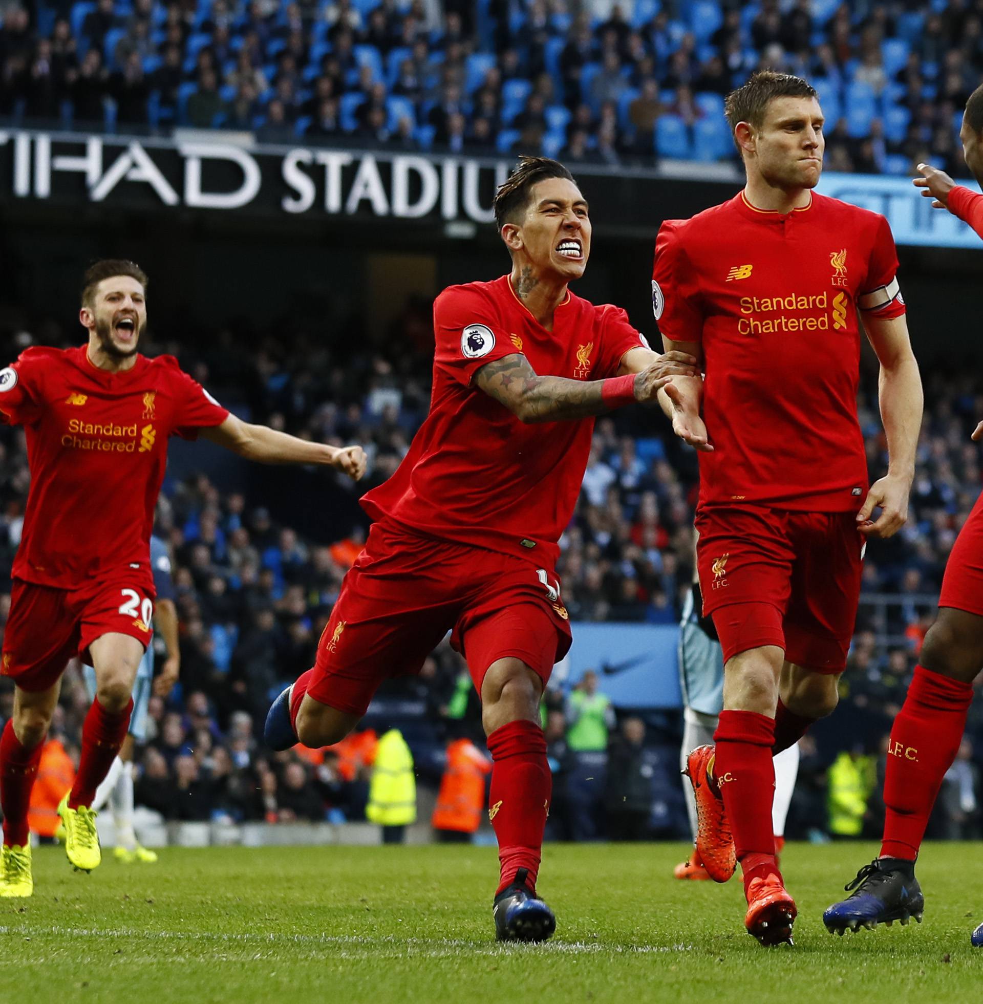 Liverpool's James Milner celebrates scoring their first goal with team mates