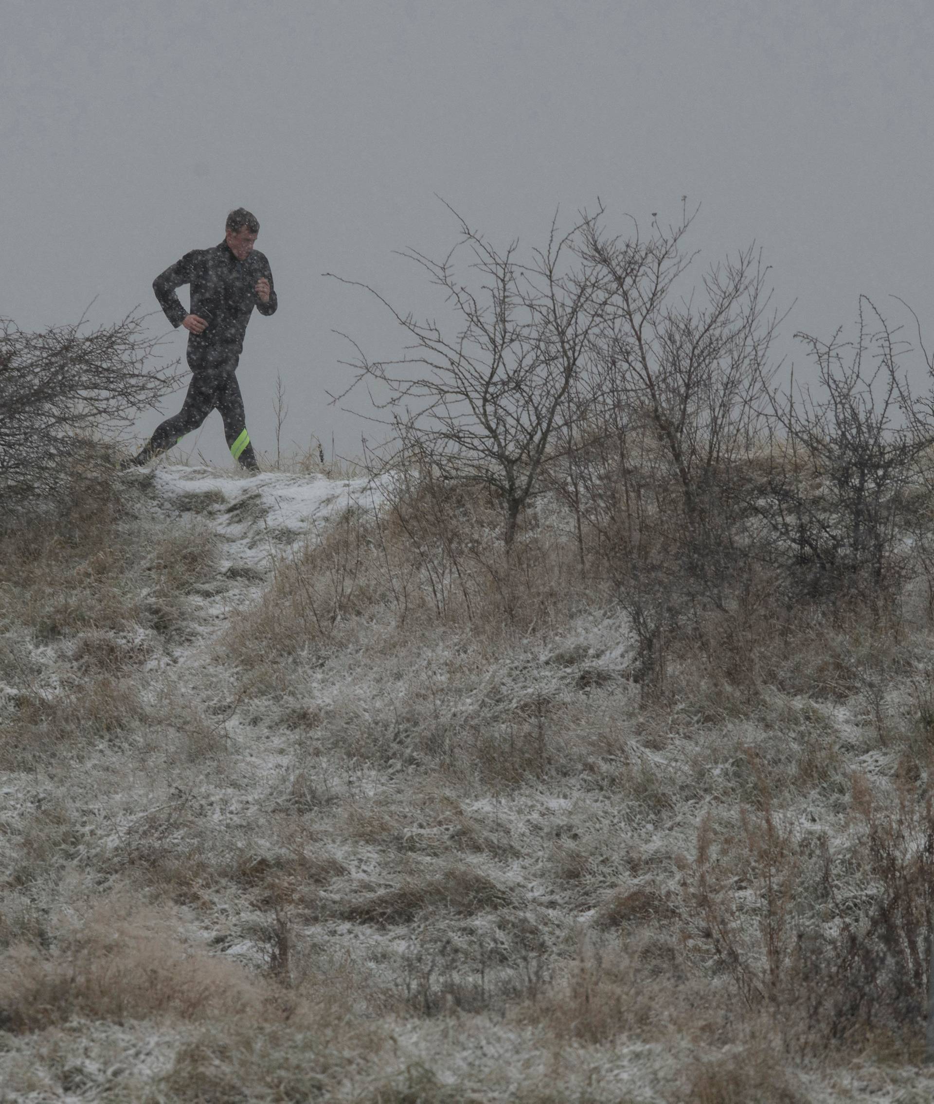 A jogger in the snow at a Ex M.O.D. WW1 and WW2 firing range. Now managed by the RSPB