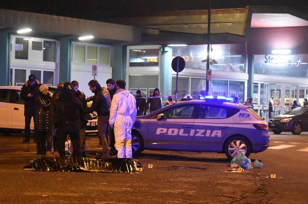 Italian Police officers work next to the body of Anis Amri, the suspect in the Berlin Christmas market truck attack, in a suburb of the northern Italian city of Milan