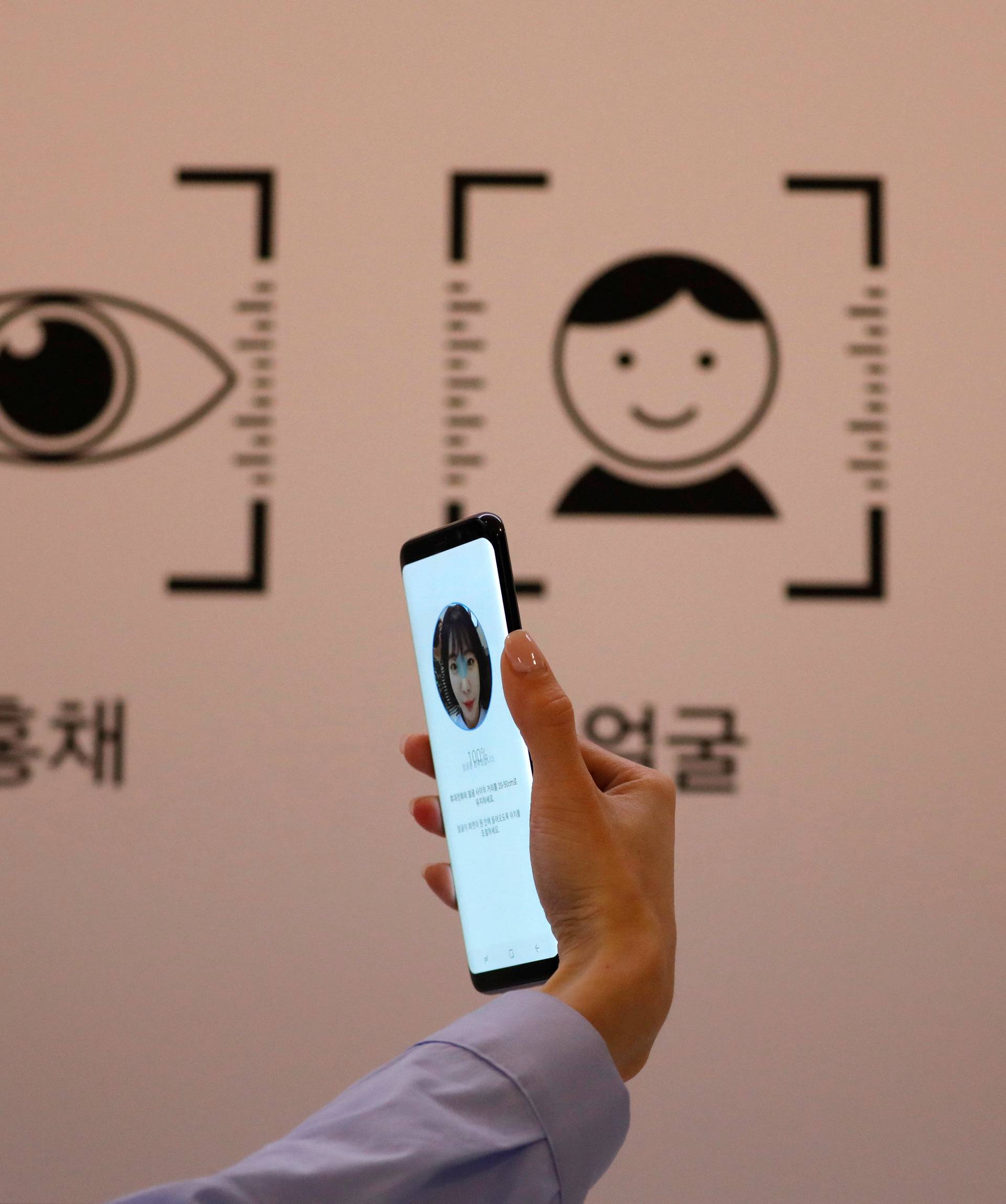 An employee demonstrates a Samsung Electronics' Galaxy S8 smartphone during a media event at a company's building in Seoul