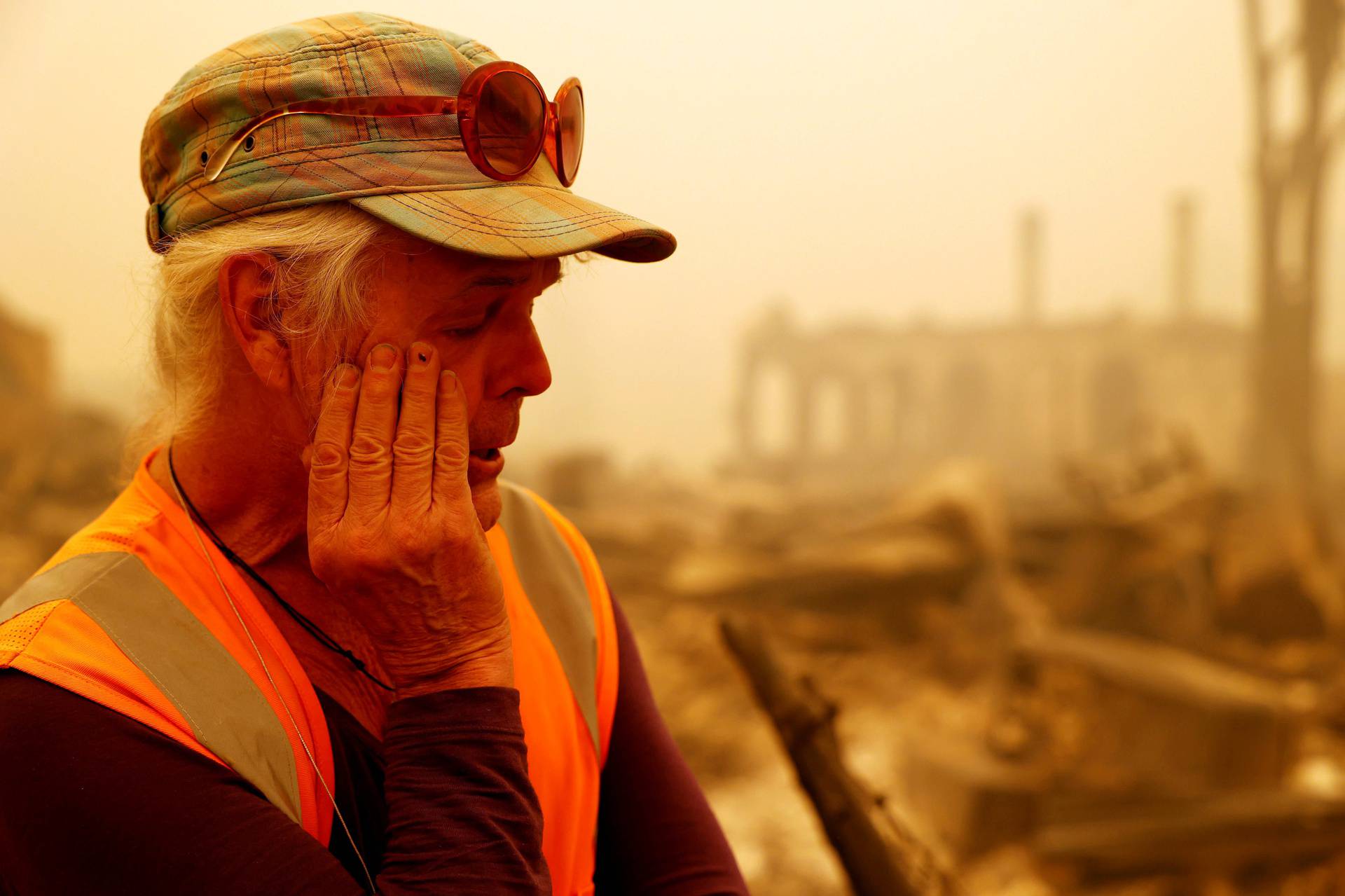 Greenville resident looks at the remains of his business after the Dixie Fire