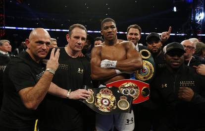Anthony Joshua celebrates with trainer Robert McCracken, promoter Eddie Hearn and his corner after winning the fight