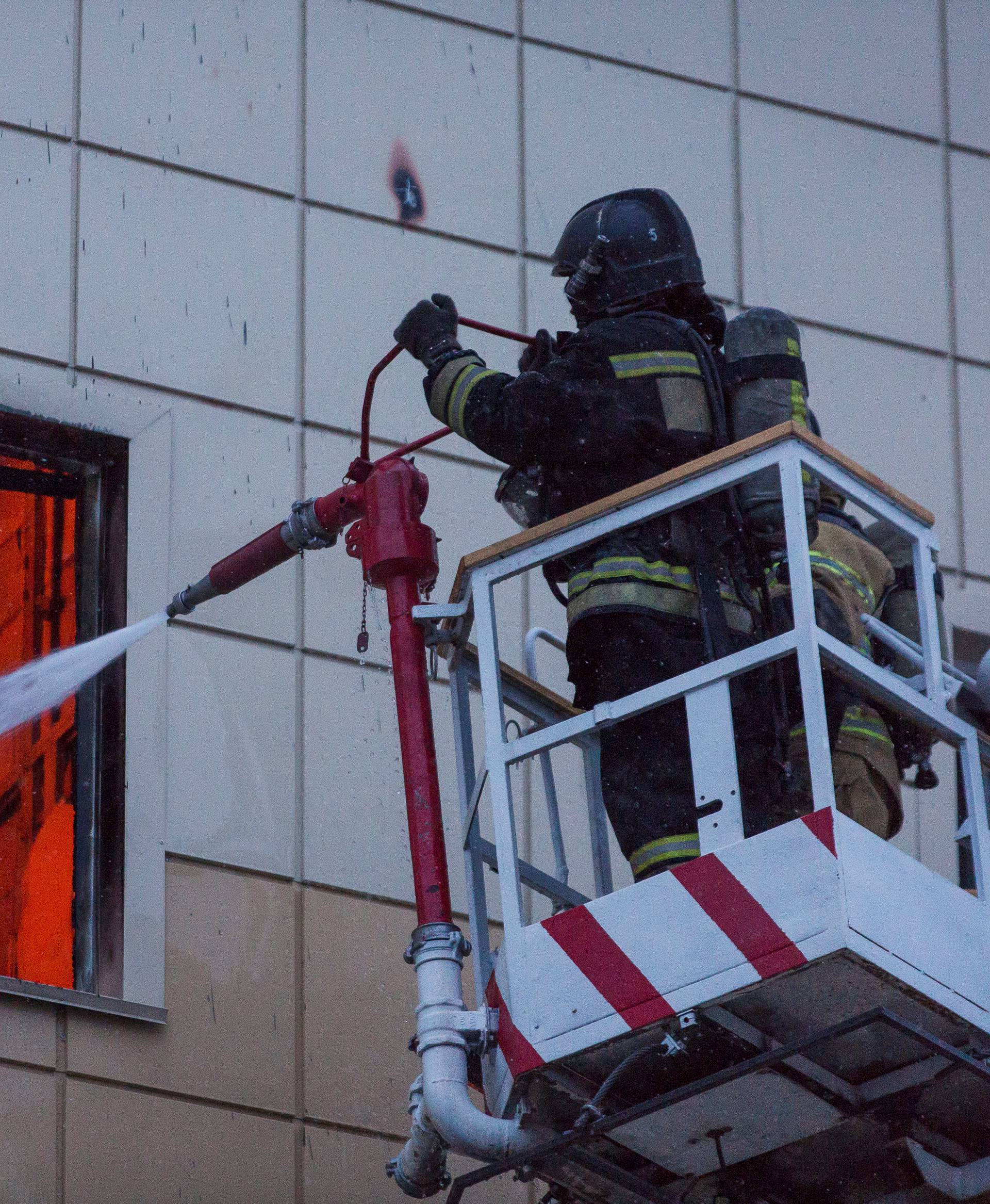 Members of the Emergency Situations Ministry work to extinguish a fire in a shopping mall in Kemerovo