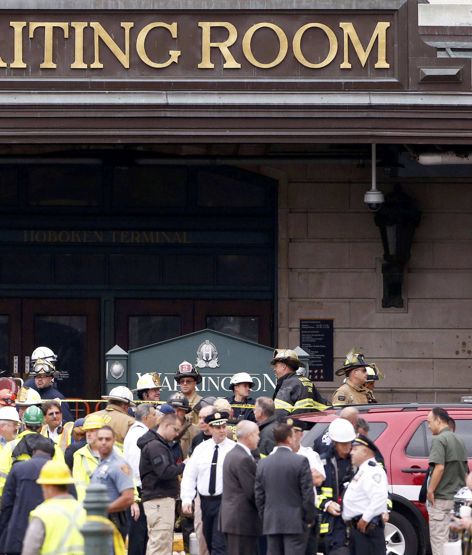 Rescue crews and police gather at the waiting room of the Hoboken train station, where a New Jersey Transit train derailed and crashed through the station, injuring more than 100 people, in Hoboken