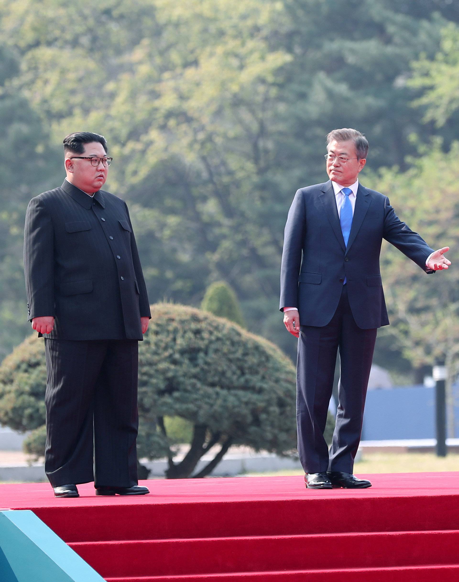 South Korean President Moon Jae-in gestures to North Korean leader Kim Jong Un during their meeting at the truce village of Panmunjom