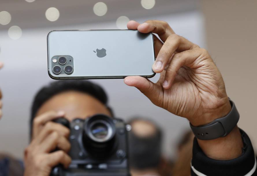 People take photos of the new iPhone  11 Pro in the demonstration room at an Apple event at their headquarters in Cupertino