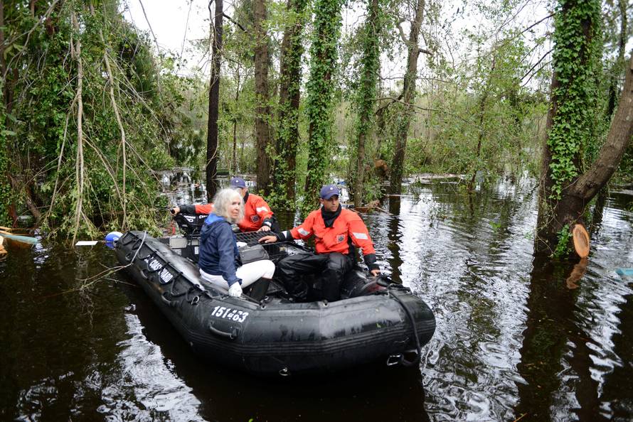 An elderly woman and her husband along with their pets are rescued by U.S. Coast Guard after their home was flooded by Hurricane Florence, in Brunswick County, North Carolina