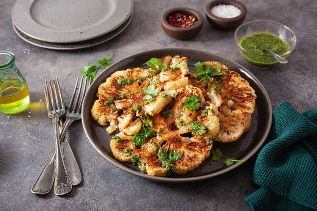 cauliflower steaks with herb sauce and spice. plant based meat s