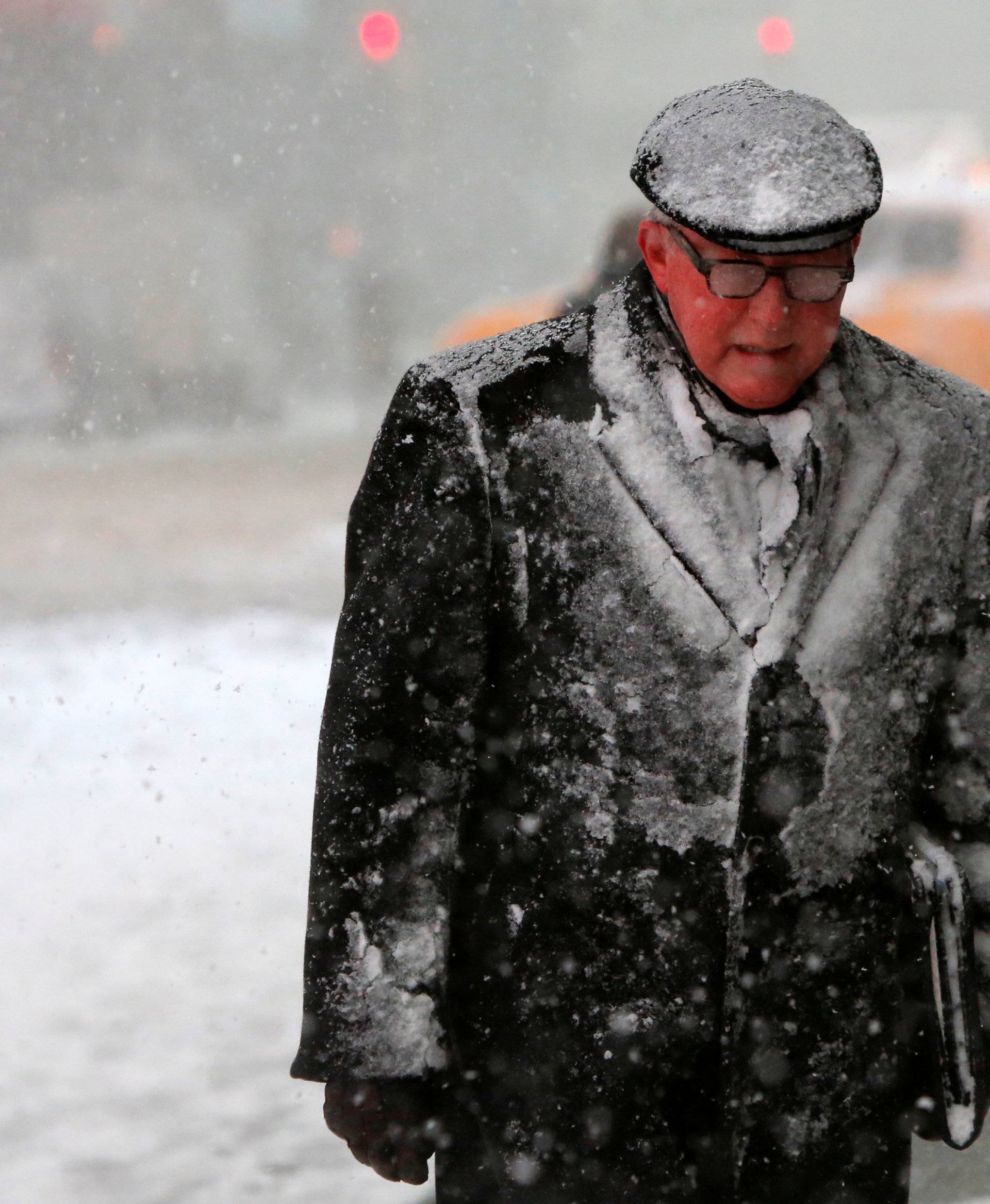 A man walks in Times Square as snow falls in Manhattan