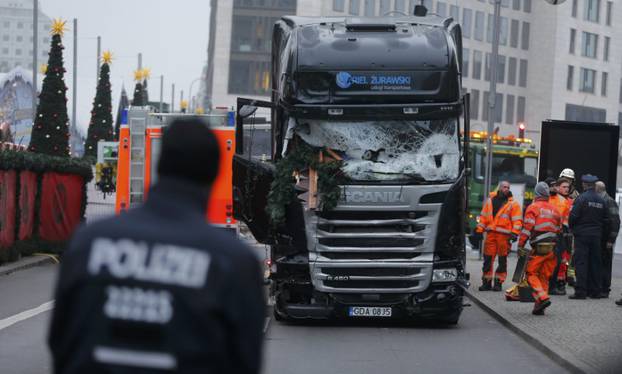 Police stand in front of the truck which ploughed last night into a crowded Christmas market in the German capital Berlin