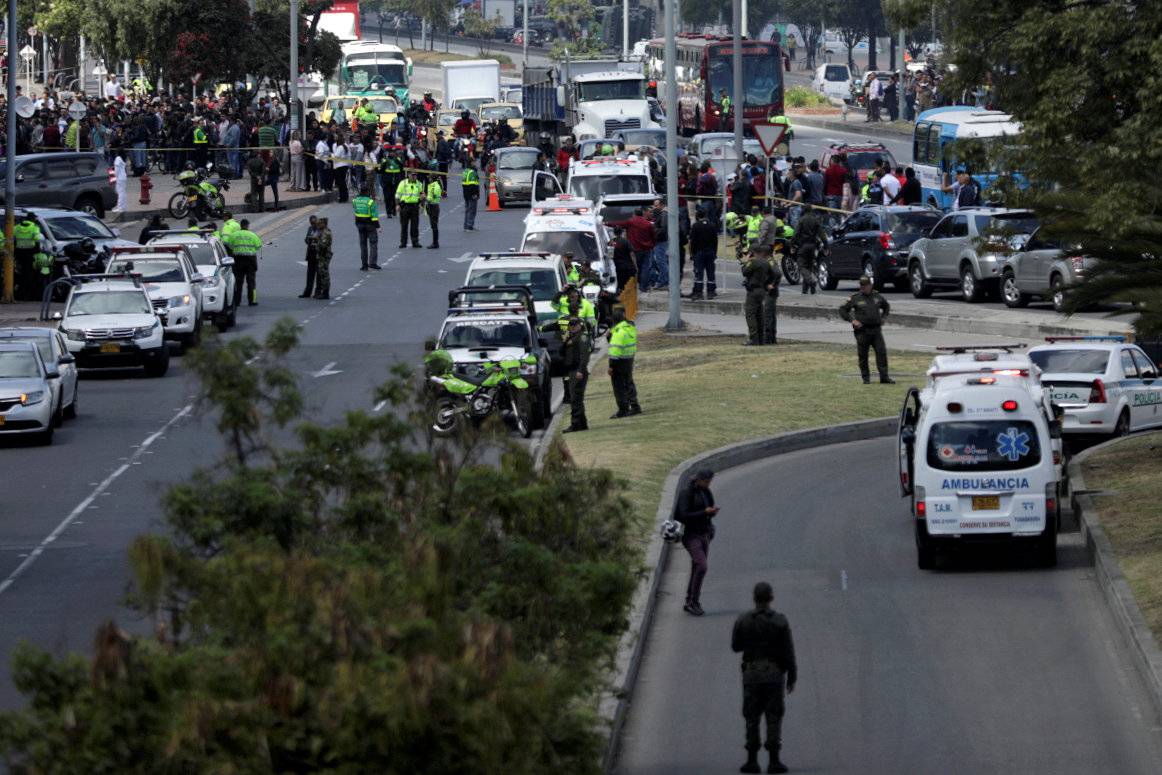 Police and security personnel work at the scene where a car bomb exploded, according to authorities, in Bogota