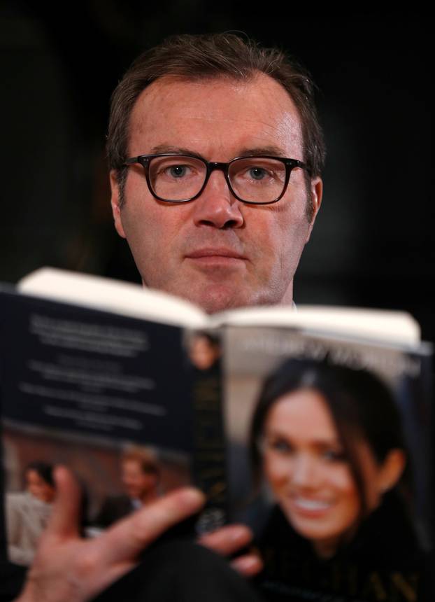 Royal biographer Andrew Morton holds his most recent book, a biography of Meghan Markle, following an interview with Reuters journalists in London