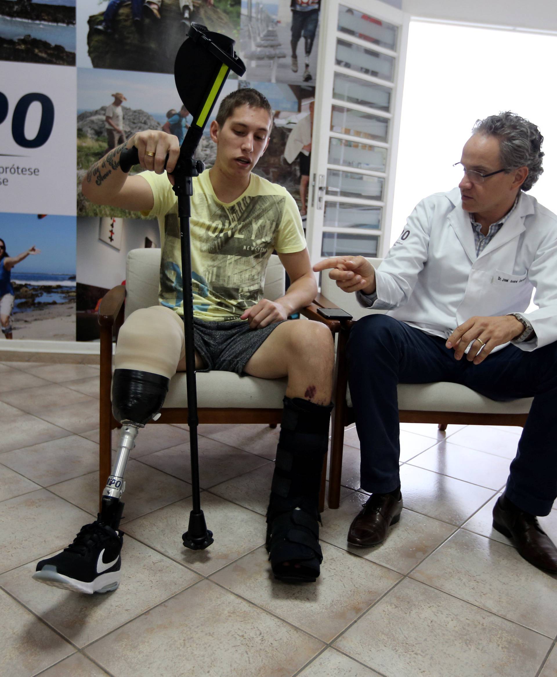 Goalkeeper Jackson Follmann, who survived when the plane carrying Brazilian soccer team Chapecoense crashed, talks with Dr. Jose Carvalho as they try on a prosthetic leg in Sao Paulo