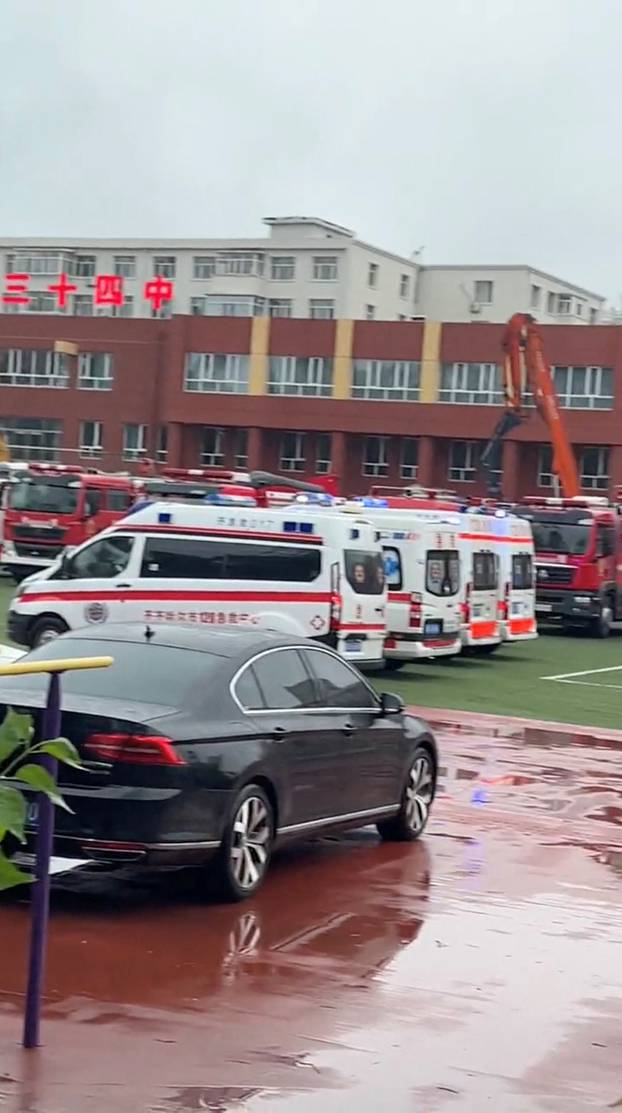 A view of emergency vehicles near the site where the roof a school gymnasium collapsed, in Qiqihar