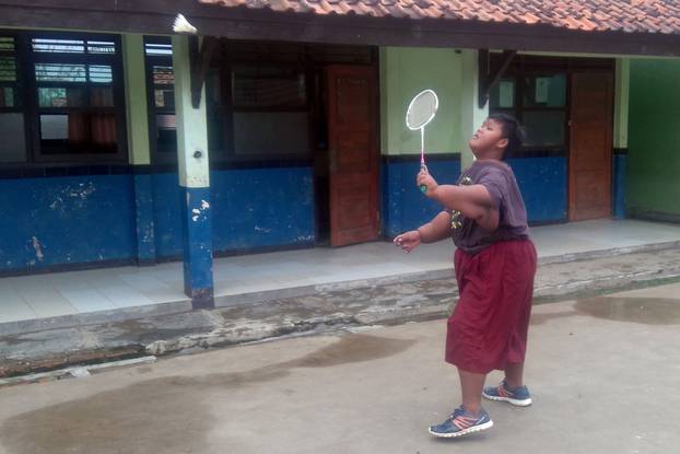 OBESE BOY PLAYS BADMINTON