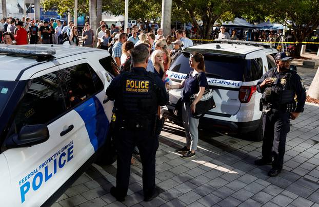 People and members of the media gather outside The Wilkie D. Ferguson Jr. United States Courthouse, in Miami