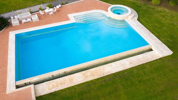 Aerial,View,Of,A,Blue,Pool,With,Stairs,To,Descend