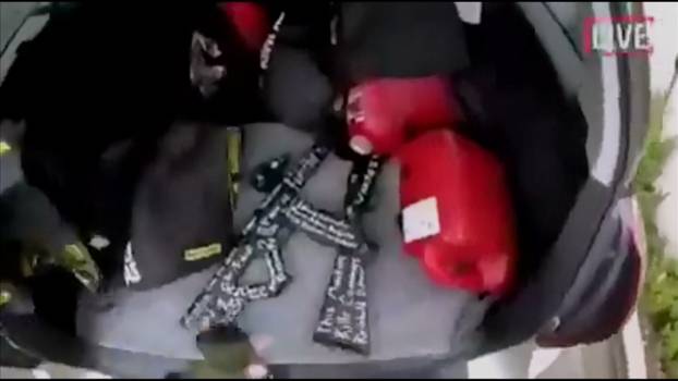 A still image taken from video circulated on social media, apparently taken by a gunman and posted online live as the attack unfolded, shows him retrieving weapons from the boot of his car in Christchurch